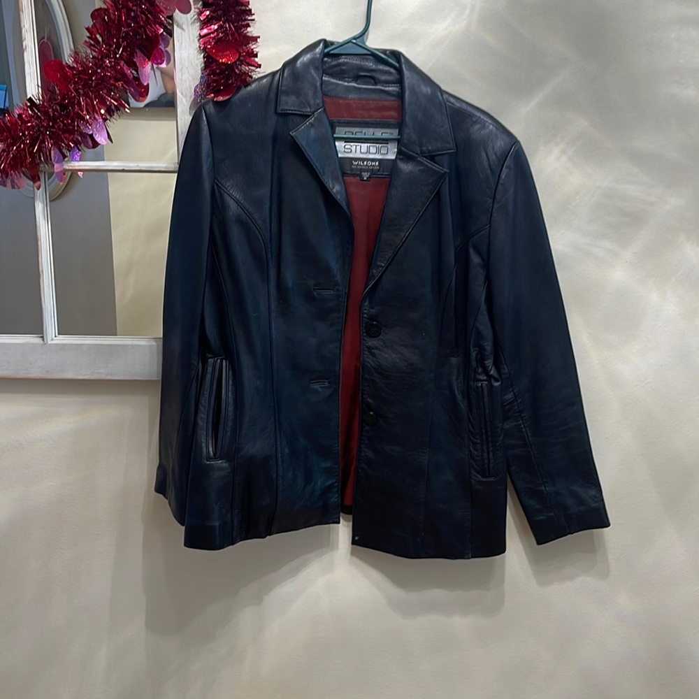 Black leather jacket with buttons and pockets